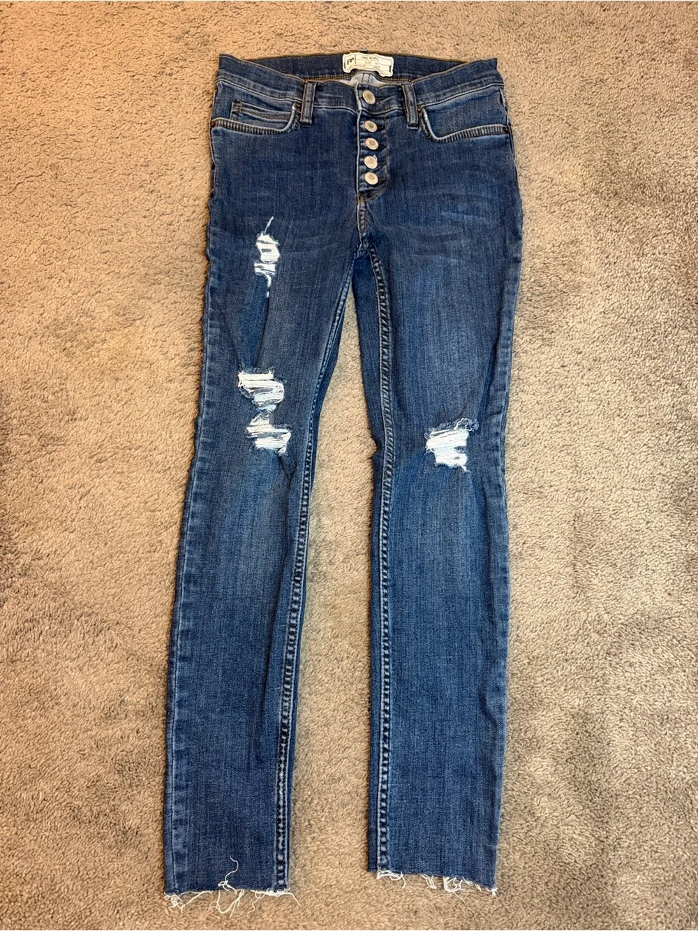 Free People indigo denim jeans with gold stitching
